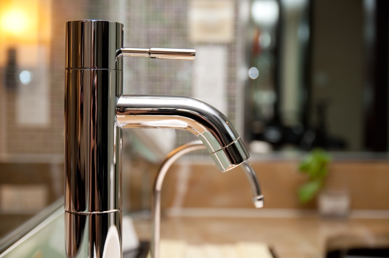 Leaking tap being repaired in Brixton